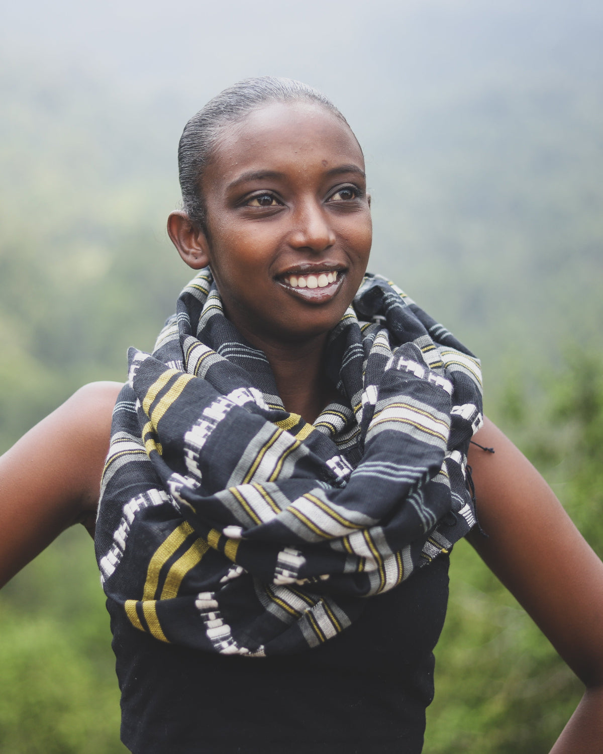 Woman wearing a patterned scarf with a blurred natural background