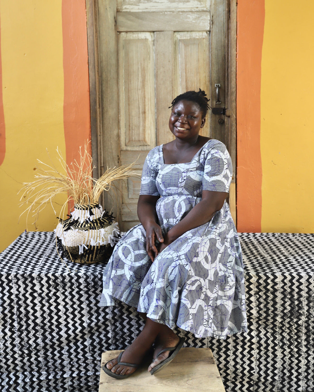 Ghanaian artisans with small basket made from Elephant grass and upcycled fabric