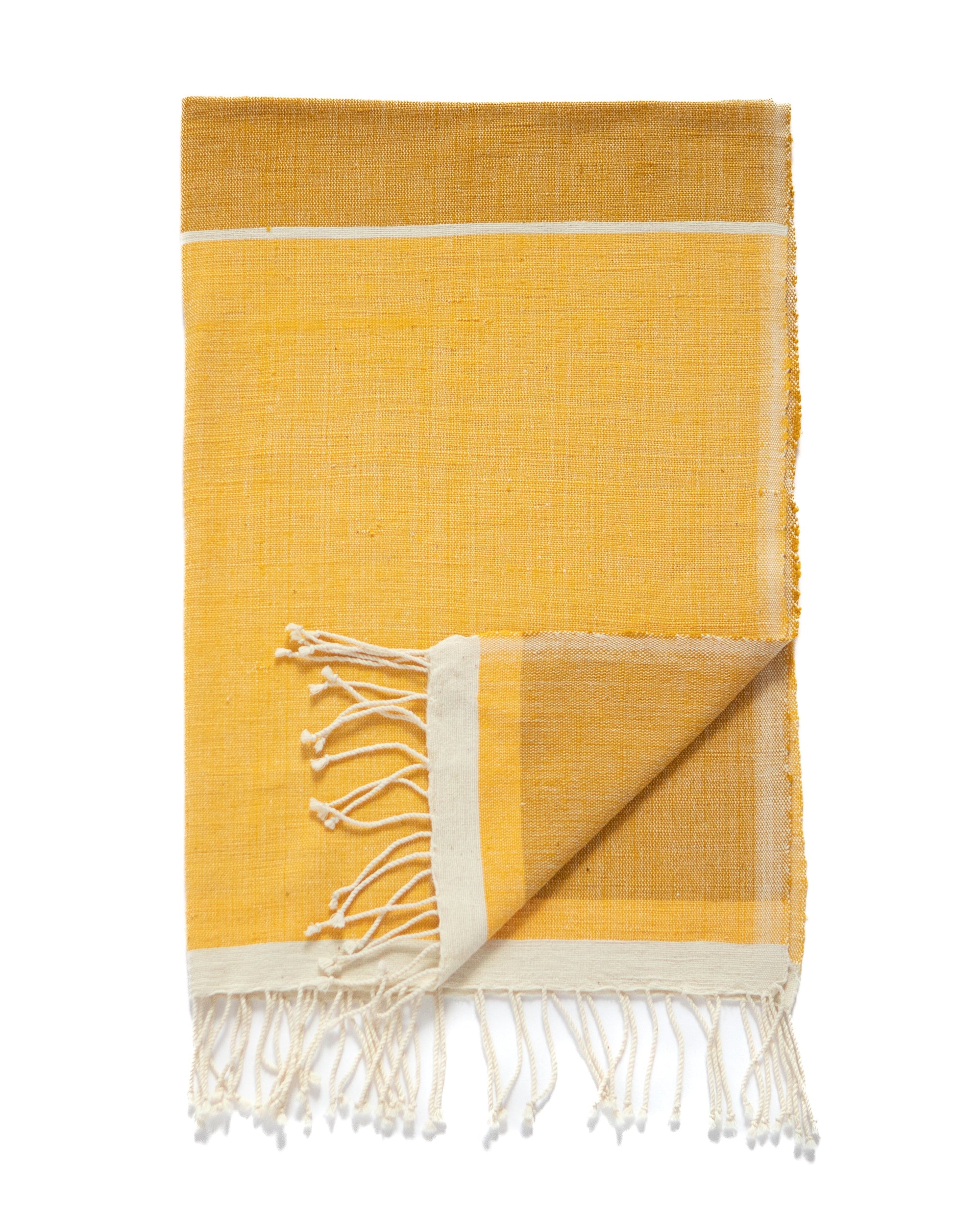 A folded 2-tone yellow woven towel with white fringe tassels and cream-colored borders, displayed on a solid white background.