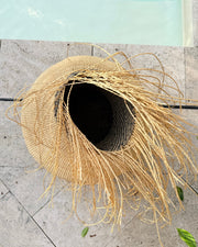 View into the Tisanie Tia basket from above, with natural fibres falling from the rim