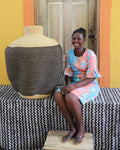 Ghanaian artisan with beautifully crafted art basket with slow waves.