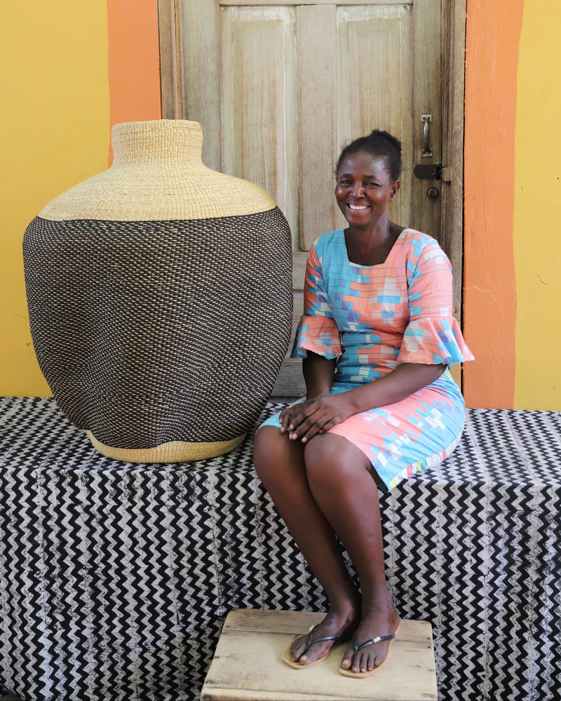Ghanaian artisan with beautifully crafted art basket with slow waves.
