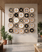 A set of 20 round baskets brought together as an installation of wall art arranged in a 4x5 grid on a beige wall in a modern, sunlit room with plants and wood flooring.