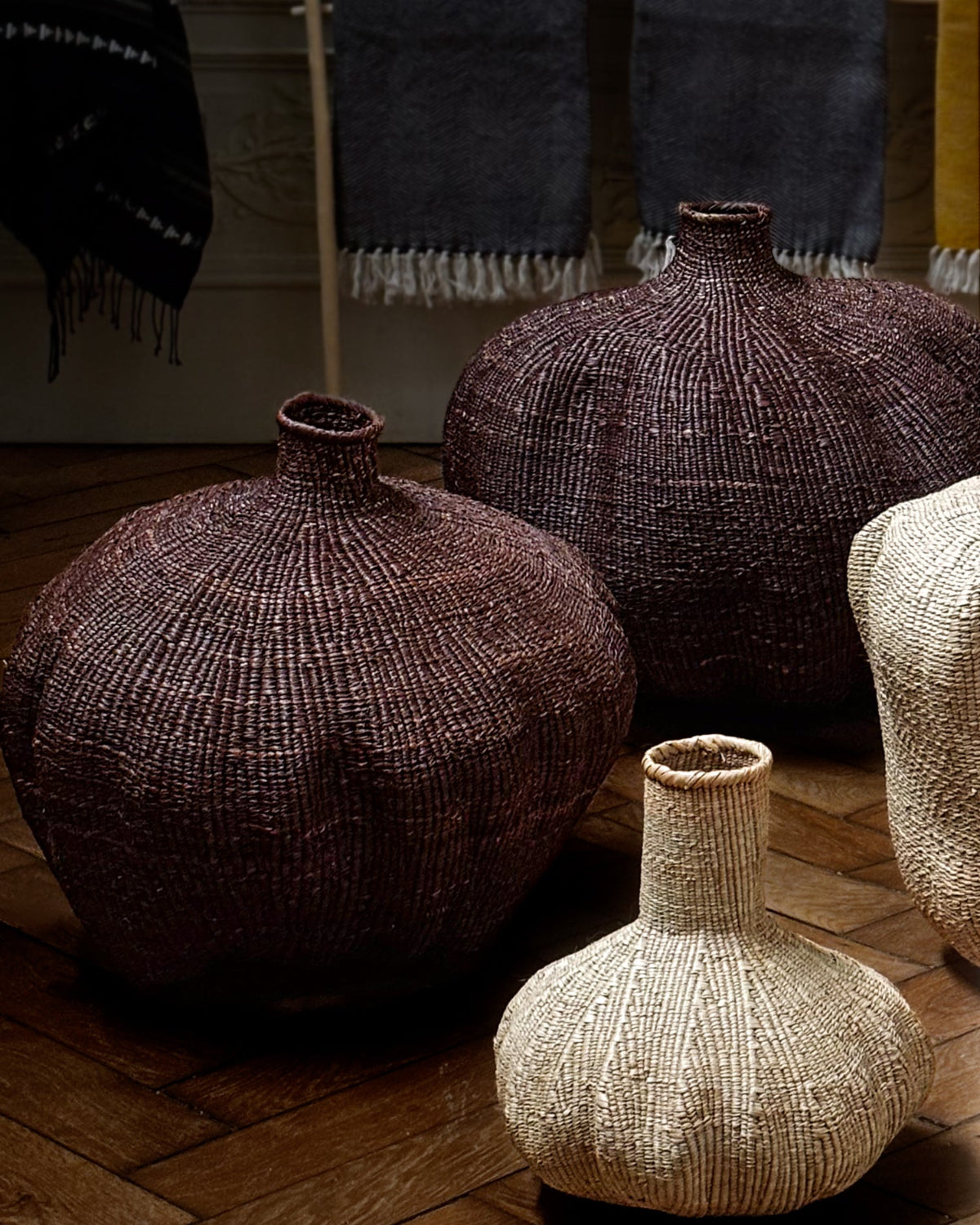 Textured vases on a wooden floor with a blurred background