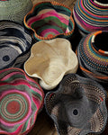 Collection of colorful woven baskets on a wooden surface